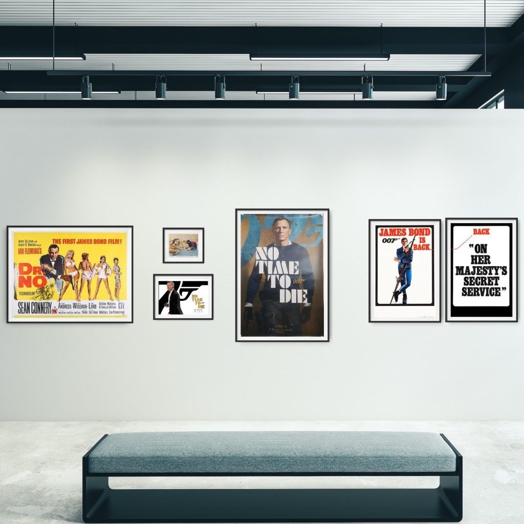 Gallery wall showing from left to right a 'Dr. No' Quad Poster, A 'Dr. No' Front of House Card, a 'No Time to Die' Mini Quad, a 'No Time to Die' UK One Sheet Poster and a set of 'On her Majesty's Secret Service Double Crown posters.