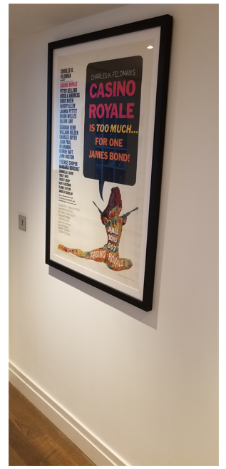 Image of a Cinema Poster framed and hung on a wall.